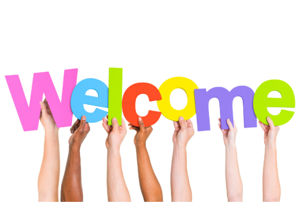 Photo of multiple hands holding up a colorful Welcome sign