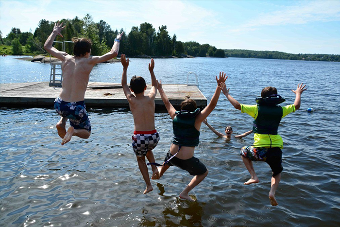 campers jumping into the lake at URJ Camp George