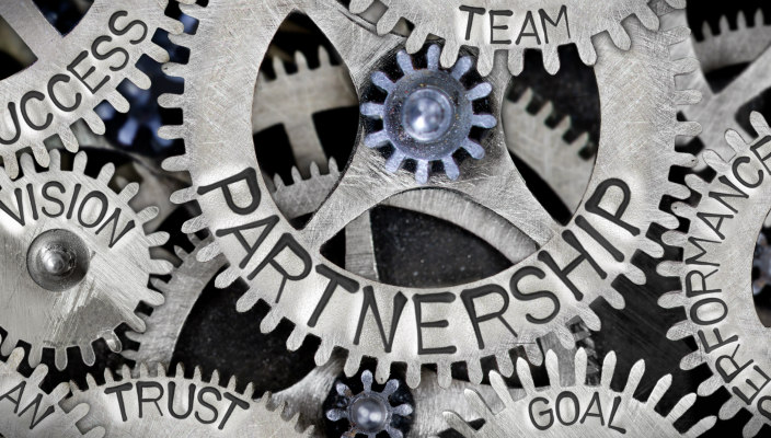 Interlocking gears; the main one of which says: Partnership