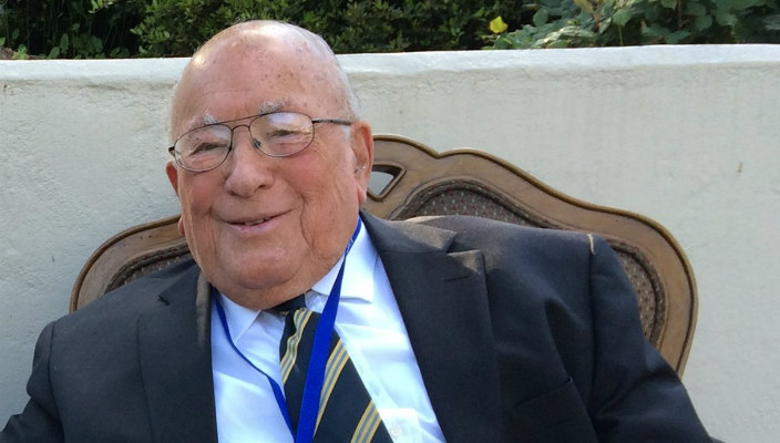 Smiling image of Rudi Scheidt sitting outdoors