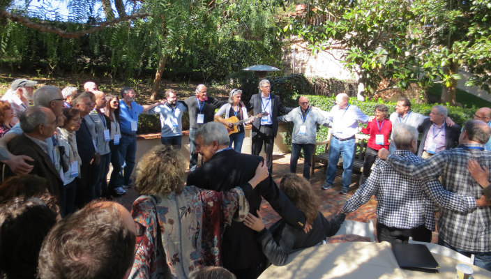 Men and women gathered in a circle outdoors