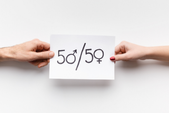 Hands holding a piece of paper that says "50/50"