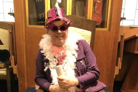 The late Joseph Dropkin dressed up on a pink hat glasses and feather boa for an annual Purim spiel